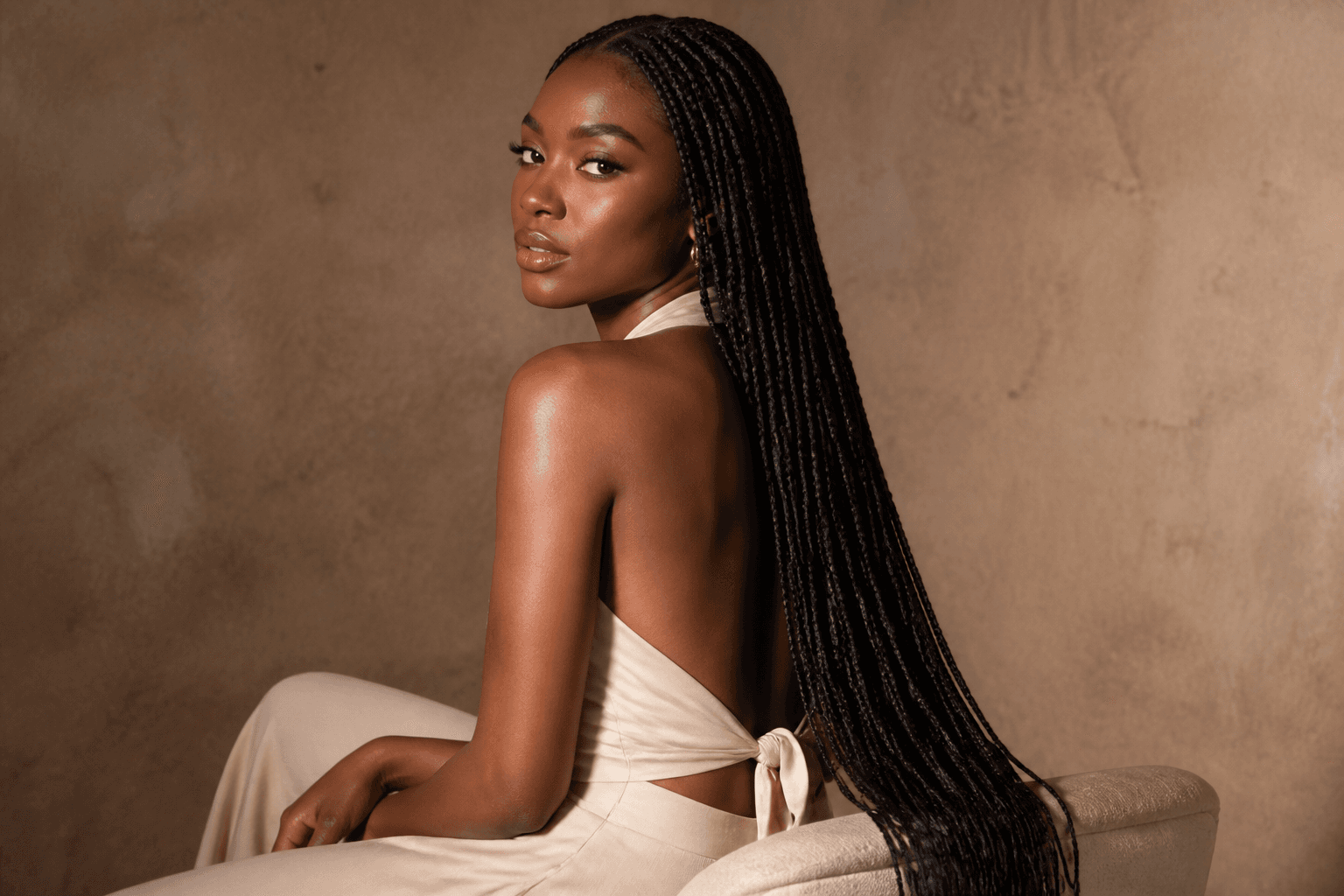 Long knotless braids seated portrait